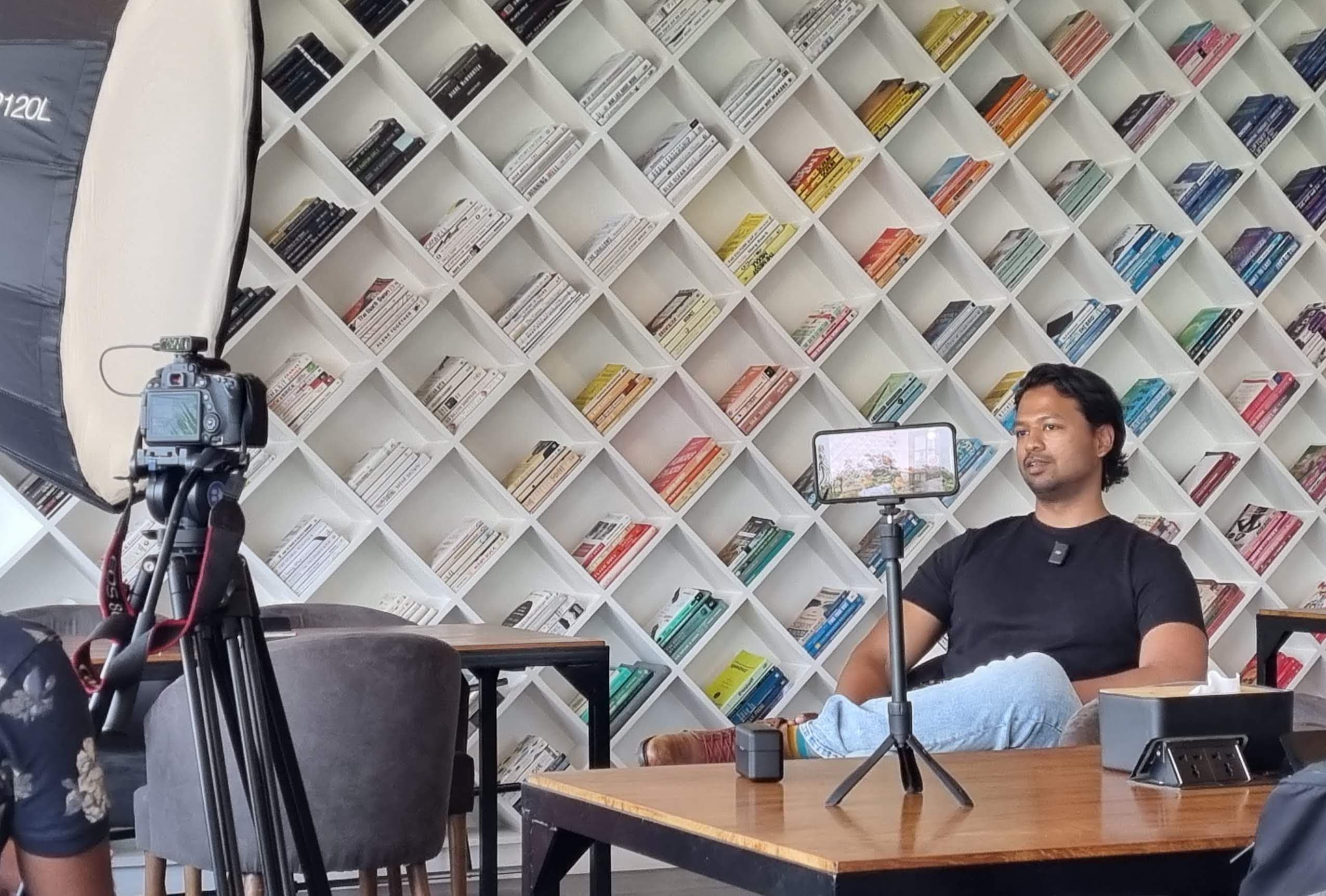 Dinesh speaking while sitting down.